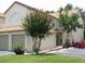 Two-story townhome with attached garage and landscaped yard at 2948 W Cottage Grove Ct # Ge, Orlando, FL 32822
