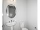 Powder bath features an oval mirror, pedestal sink, and tile floors at 5222 Sw 88Th Cir, Ocala, FL 34481