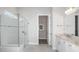 Bright bathroom with glass enclosed shower and double sink vanity with white cabinets at 5222 Sw 88Th Cir, Ocala, FL 34481