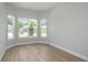Light-filled bedroom with hardwood floors and large windows offering outdoor views at 5222 Sw 88Th Cir, Ocala, FL 34481