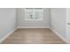 Bright bedroom features wood-look floors, a window, fresh paint, and white trim at 5222 Sw 88Th Cir, Ocala, FL 34481