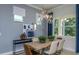 Bright dining area with modern lighting and large windows overlooking backyard at 5222 Sw 88Th Cir, Ocala, FL 34481