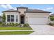 Charming home featuring a well-manicured lawn, tasteful landscaping, and a brick-paved driveway at 5222 Sw 88Th Cir, Ocala, FL 34481