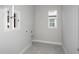 Laundry room featuring tiled floors, access door, and window for natural light at 5222 Sw 88Th Cir, Ocala, FL 34481