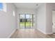 Bright living room with wood flooring and sliding glass doors that open to the backyard at 5222 Sw 88Th Cir, Ocala, FL 34481