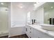 Modern bathroom with double vanity, soaking tub, and walk-in shower at 3088 Sire Trl, Lakeland, FL 33811