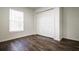 Bright bedroom with dark wood floors and window blinds at 3088 Sire Trl, Lakeland, FL 33811