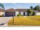 One-story house with brown roof, attached garage, and a landscaped yard at 3088 Sire Trl, Lakeland, FL 33811
