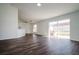 Open living space with kitchen island, hardwood floors and sliding doors at 3088 Sire Trl, Lakeland, FL 33811