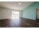 Living room with sliding glass doors and dark hardwood floors at 3088 Sire Trl, Lakeland, FL 33811