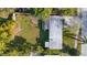 Aerial view showing a single-story home with a large backyard and surrounding trees at 5883 Dogwood Dr, Orlando, FL 32807