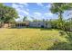 Large backyard with grassy lawn and home view at 5883 Dogwood Dr, Orlando, FL 32807