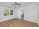 Well-lit bedroom with ceiling fan and vinyl flooring at 5883 Dogwood Dr, Orlando, FL 32807