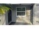Front entrance with black door and sidelight windows at 5883 Dogwood Dr, Orlando, FL 32807