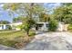 Single story home with a large yard and driveway at 5883 Dogwood Dr, Orlando, FL 32807