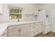 Updated kitchen with white cabinets, quartz countertops, and new flooring at 5883 Dogwood Dr, Orlando, FL 32807