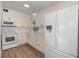Bright kitchen features white cabinets, new appliances, and wood-look flooring at 5883 Dogwood Dr, Orlando, FL 32807