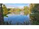 Peaceful lake view with lush greenery and a small boat at 5883 Dogwood Dr, Orlando, FL 32807