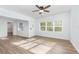 Bright living room with wood-look floors and ceiling fan at 5883 Dogwood Dr, Orlando, FL 32807