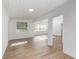 Open concept living area with wood-look floors and large windows at 5883 Dogwood Dr, Orlando, FL 32807