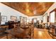 Antique dining set anchors this hardwood-floor dining room with wood ceilings at 15220 Nw 41St Ter, Reddick, FL 32686