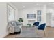 Modern living room featuring a gray sofa and blue accent chairs at 1875 S Merrick Dr, Deltona, FL 32725