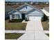 Single-story home with light blue exterior, two-car garage, and well-maintained lawn at 2531 Ryland Falls Dr, Lakeland, FL 33811