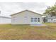 Back of house showing a screened porch and yard at 50989 Highway 27 # 3, Davenport, FL 33897