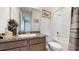 Clean bathroom with a shower/tub combo and granite vanity at 1076 Sugarwood St, Davenport, FL 33837