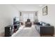 Bright bonus room with TV, comfortable seating, and plenty of natural light at 1076 Sugarwood St, Davenport, FL 33837