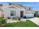Two-story house with a two-car garage, landscaping, and stone accents at 1076 Sugarwood St, Davenport, FL 33837