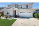 Two-story house with a two-car garage and well-manicured lawn at 1076 Sugarwood St, Davenport, FL 33837