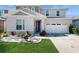 Two-story house with a two-car garage, landscaping, and stone accents at 1076 Sugarwood St, Davenport, FL 33837