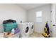 Laundry room with washer, dryer, and storage space at 1076 Sugarwood St, Davenport, FL 33837