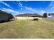 Large backyard with covered patio, grassy area, and privacy fence at 164 Sunrise Hill Ln, Auburndale, FL 33823