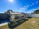 Landscaped backyard with greenhouse and storage shed at 164 Sunrise Hill Ln, Auburndale, FL 33823