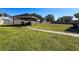 Large backyard with covered patio and spacious grassy area at 164 Sunrise Hill Ln, Auburndale, FL 33823