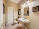 Clean and bright bathroom with pedestal sink and toilet at 164 Sunrise Hill Ln, Auburndale, FL 33823