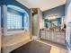 Elegant bathroom with soaking tub, walk-in shower, and dual vanity at 164 Sunrise Hill Ln, Auburndale, FL 33823