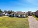 House with a paver driveway and lush green lawn at 164 Sunrise Hill Ln, Auburndale, FL 33823
