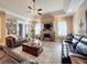 Spacious living room with a fireplace and leather furniture at 164 Sunrise Hill Ln, Auburndale, FL 33823