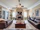Spacious living room with a fireplace and leather furniture at 164 Sunrise Hill Ln, Auburndale, FL 33823