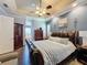 Main bedroom with king-size bed and access to en-suite bathroom at 164 Sunrise Hill Ln, Auburndale, FL 33823