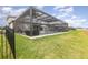 Great view of the screened-in in-ground pool and patio area from the grassy backyard at 3200 Canna Lily Pl, Clermont, FL 34711