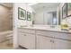 Bathroom featuring a double vanity, large mirror, and tiled shower with a tub at 3200 Canna Lily Pl, Clermont, FL 34711