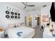 Bedroom featuring white decor, vinyl record art, and access to the bathroom at 3200 Canna Lily Pl, Clermont, FL 34711