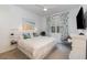 Stylish bedroom with beach-themed decor, including a beach artwork and palm patterned curtains at 3200 Canna Lily Pl, Clermont, FL 34711