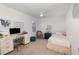 Bright bedroom featuring a desk, comfortable chair, and a bed at 3200 Canna Lily Pl, Clermont, FL 34711