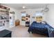 Bright bedroom with a white bookcase and a large window overlooking the yard at 3200 Canna Lily Pl, Clermont, FL 34711