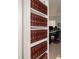 Bookshelf with red books and a view to the workspace at 3200 Canna Lily Pl, Clermont, FL 34711